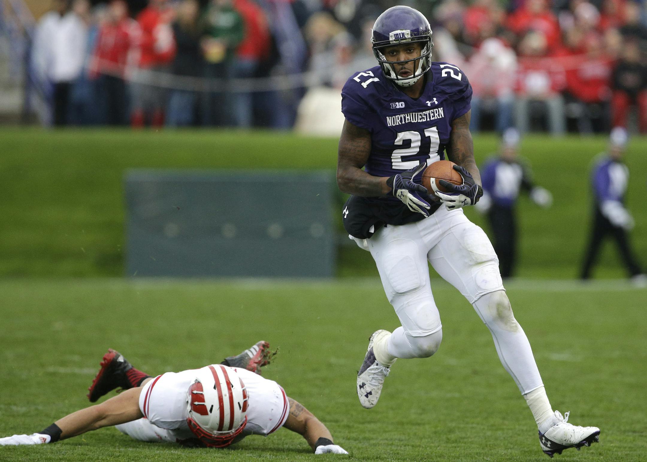 Northwestern wide receiver Kyle Prater (21), right, runs with the ball against Wisconsin linebacker Jesse Hayes (41) during the first half of an NCAA college football game in Evanston, Ill., Saturday, Oct. 4, 2014. (AP Photo/Nam Y. Huh)