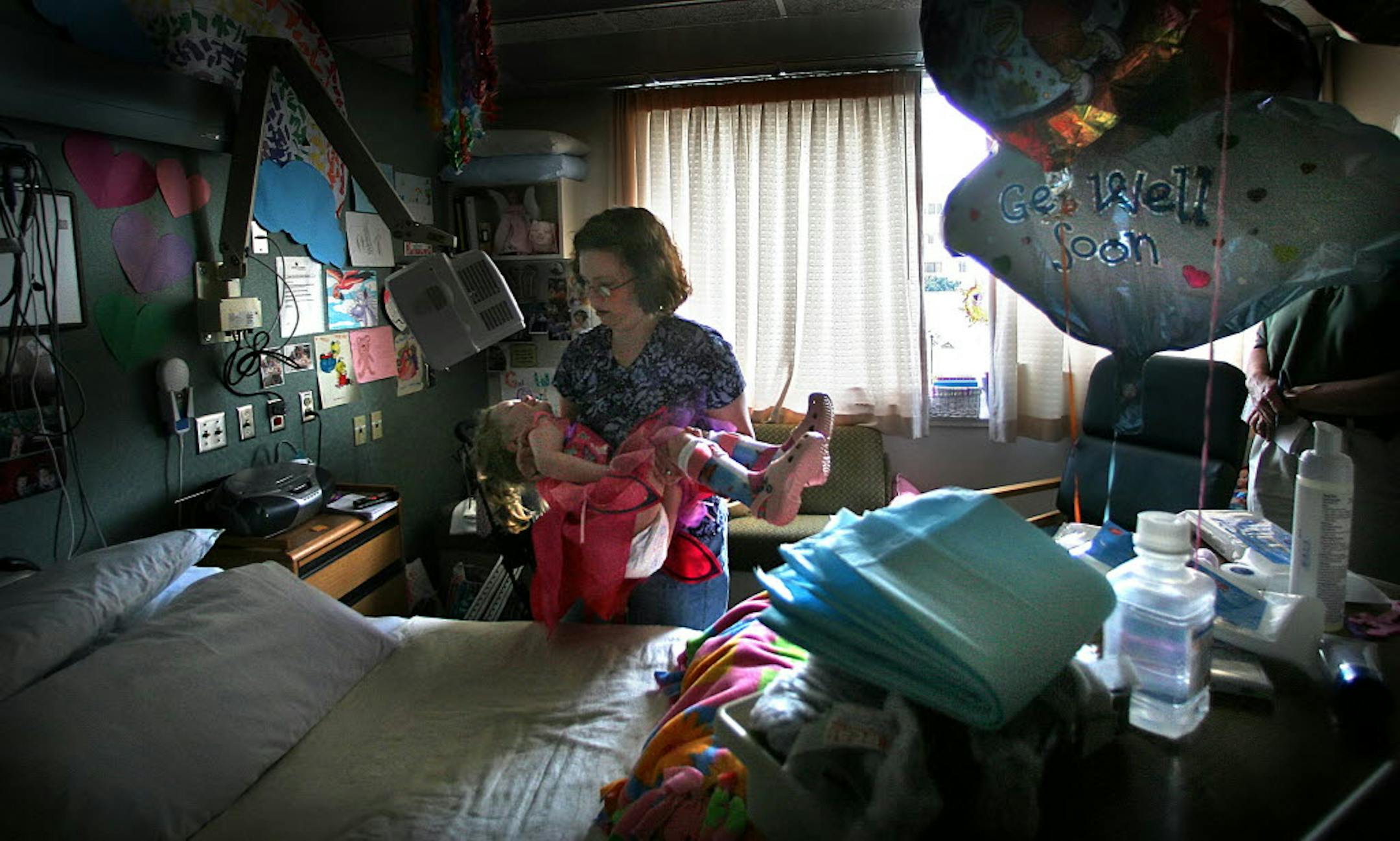 Christina Prindle lifted her five-year-old daughter, Annika, into her bed at Gillette Children's Hospital. Annika was severely injured when a tornado struck the Prindle's home in Hugo. Nathanial Prindle, 2, was killed in the tornado.