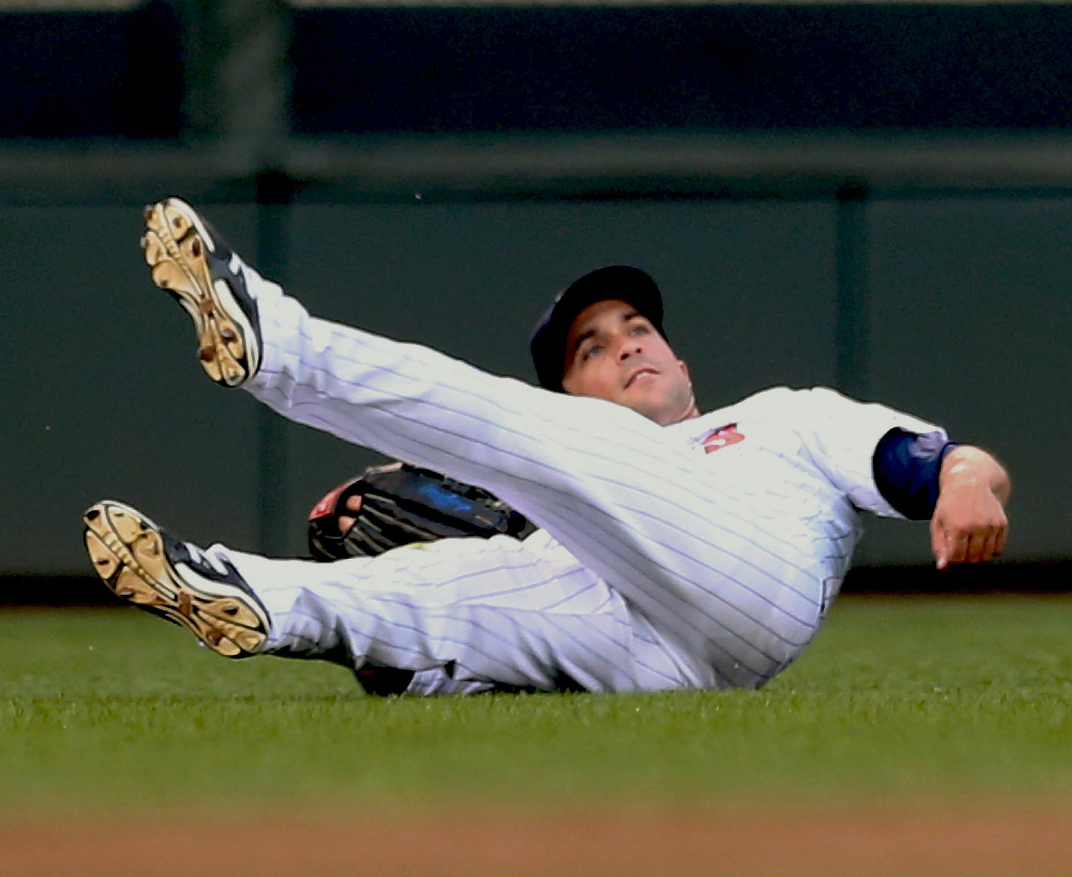 Minnesota Twins left fielder Sam Fuld watches his throw to the infield to keep Tampa Bay Rays' Curt Casali from advancing, after Fuld caught a shallow fly ball hit by Kevin Kiermaier in the third inning of a baseball game, Friday, July 18, 2014, in Minneapolis. (AP Photo/Jim Mone)