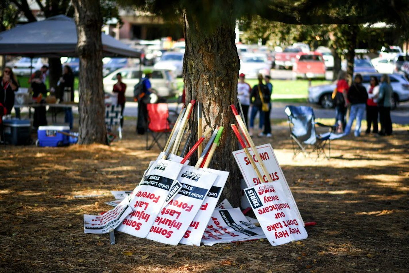 Striking nurses out down their picket signs Tuesday as they gathered outside Abbott Northwestern Hospital in Minneapolis hours after negotiators reached a tentative contract agreement.