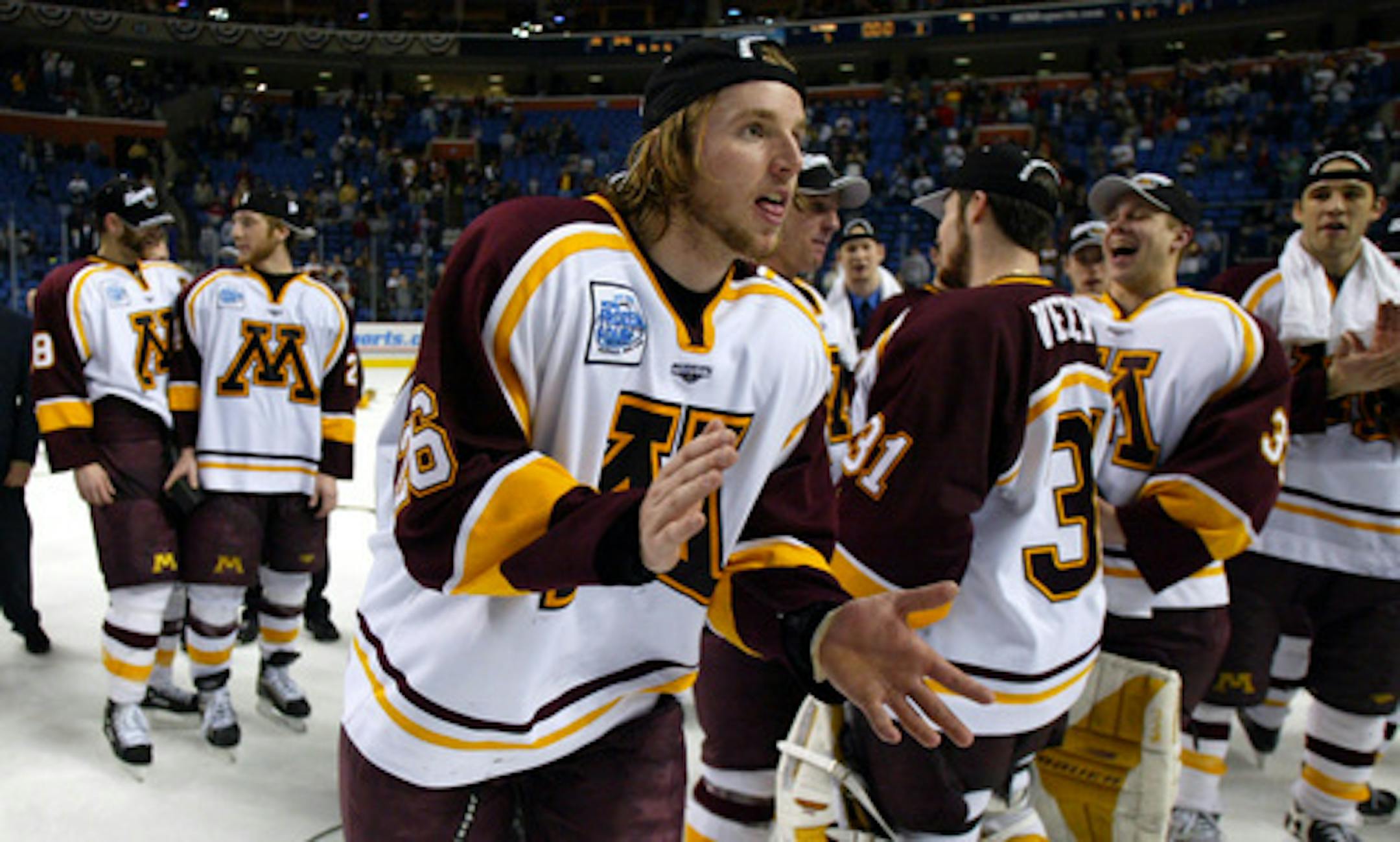 The Gophers' Thomas Vanek skated to get his national medal as his teammates celebrated after beating New Hampshire 5-1 in the NCAA championship game on April 12, 2003, in Buffalo, N.Y.