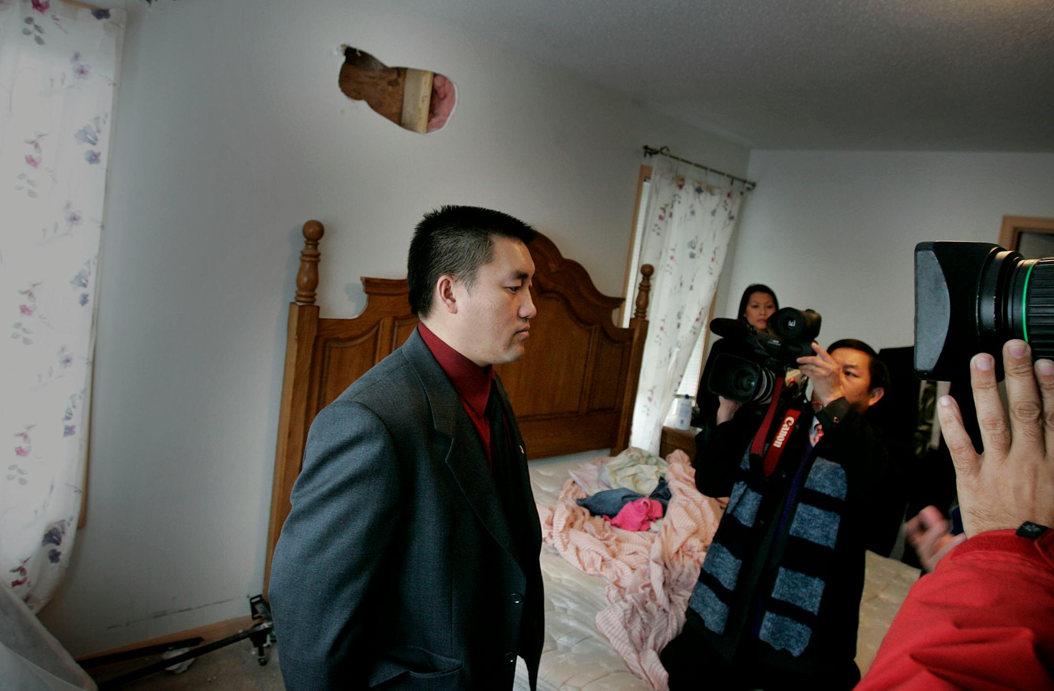 DAVID JOLES � djoles@startribune.comMinneapolis, MN - Dec. 18, 2007 - Vang Khang, in the bedroom of his family's northside home where a piece of sheetrock riddled with bullet holes had been cut out. Police mistakedly raided Khang's home early Sunday morning and exchanged gunfire with Khang before they realized their mistake. Khang and his wife Yee Moua have six children and four of them hid in a bathroom closet when the gunfire was exchanged. Khang and family members found 22 bullet holes in th