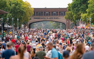 Thousands of people move down Liggett Street on the first day of the 2023 Minnesota State Fair in Falcon Heights.