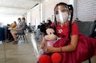 Genesis Cuellar, 8, a migrant from El Salvador, sat in a waiting area to be processed by Team Brownsville, a humanitarian group, helping migrants rele