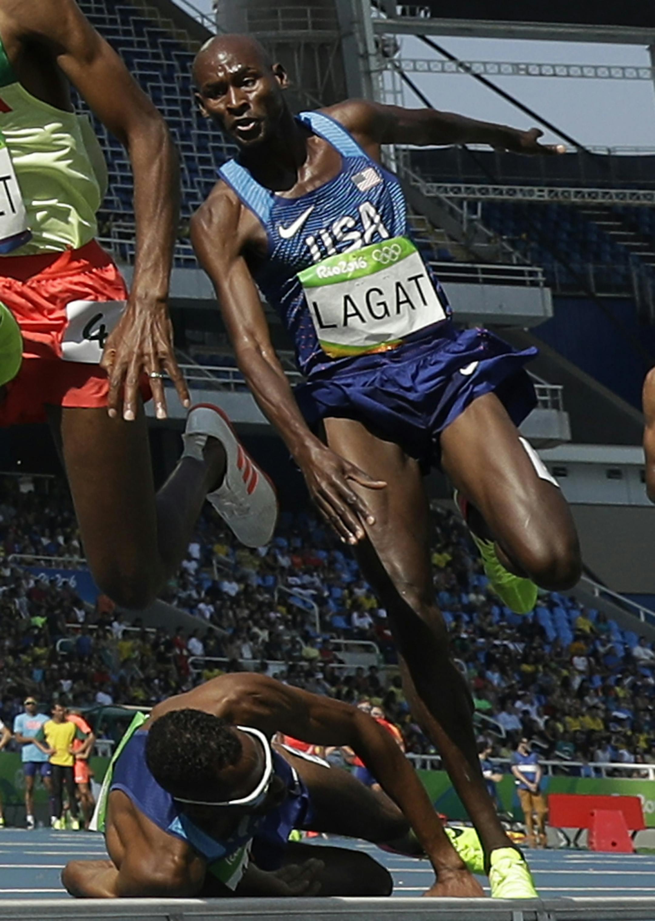 United States' Bernard Lagat leaps over United States' Hassan Mead who fell in a men's 5000-meter heat during the athletics competitions of the 2016 Summer Olympics at the Olympic stadium in Rio de Janeiro, Brazil, Wednesday, Aug. 17, 2016.
