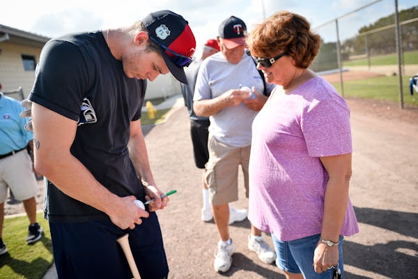 Twins outfielder Max Kepler signed a ball for Pam Finley, of Finland, Minn., as Kepler made his way to an optional workout Monday. ] AARON LAVINSKY �