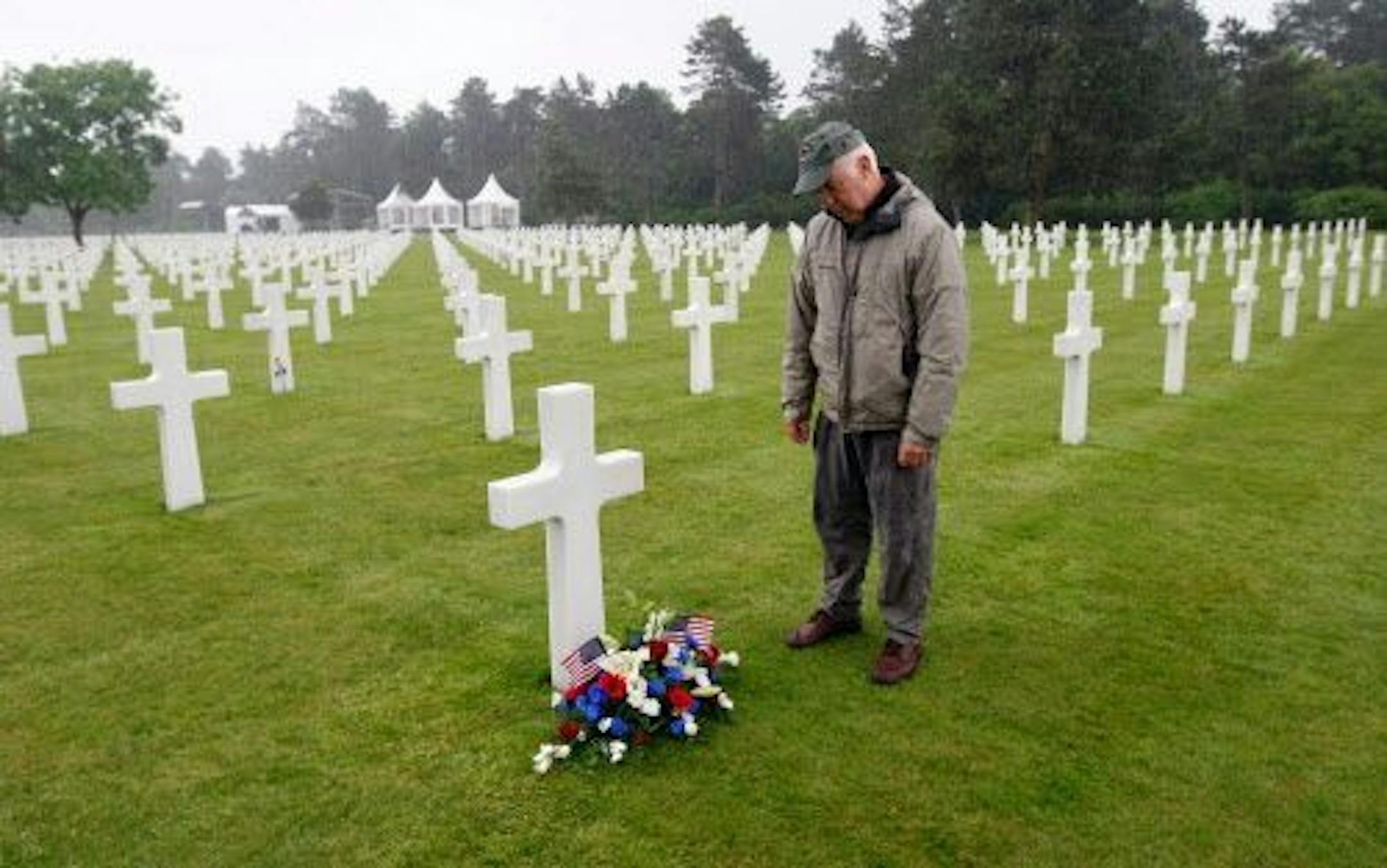 Paul Clifford, 70, from Boston MA, USA. stands after placing flowers on the grave of Walter J. Gunther Jr, the uncle of his best friend, in the Normandy American Cemetery and Memorial, in Colleville sur Mer, France, Wednesday June 4, 2014.