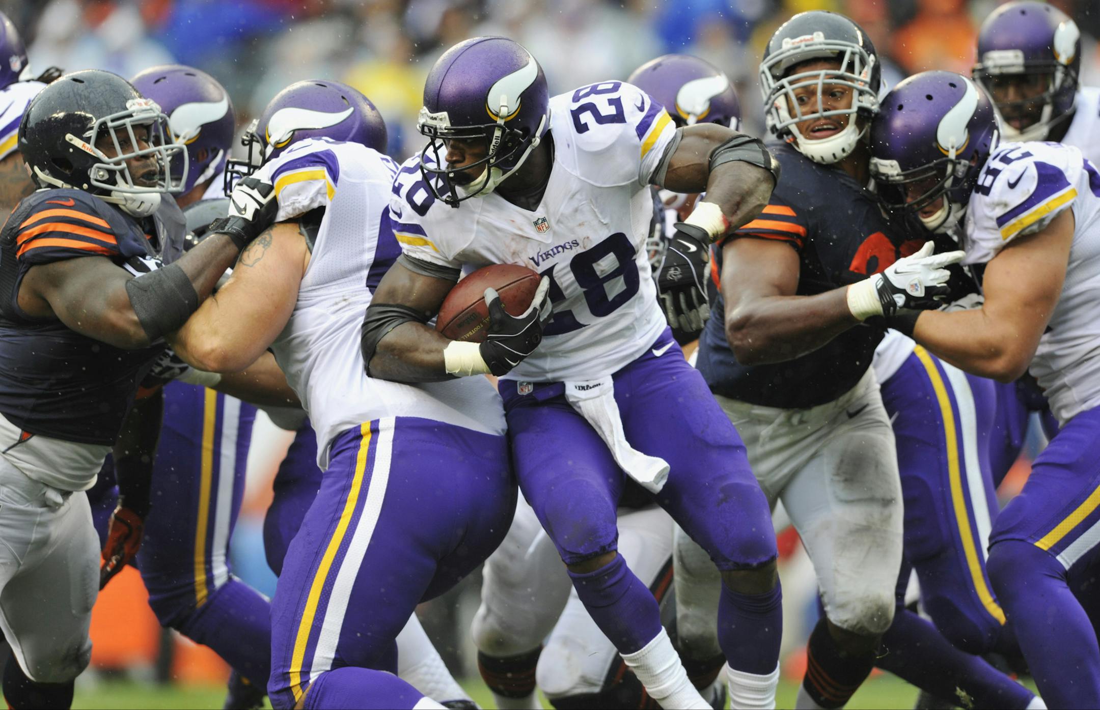 Minnesota Vikings running back Adrian Peterson (28) rushes against the Chicago Bears during the first half of an NFL football game on Sunday, Sept. 15, 2013, in Chicago. (AP Photo/Jim Prisching)