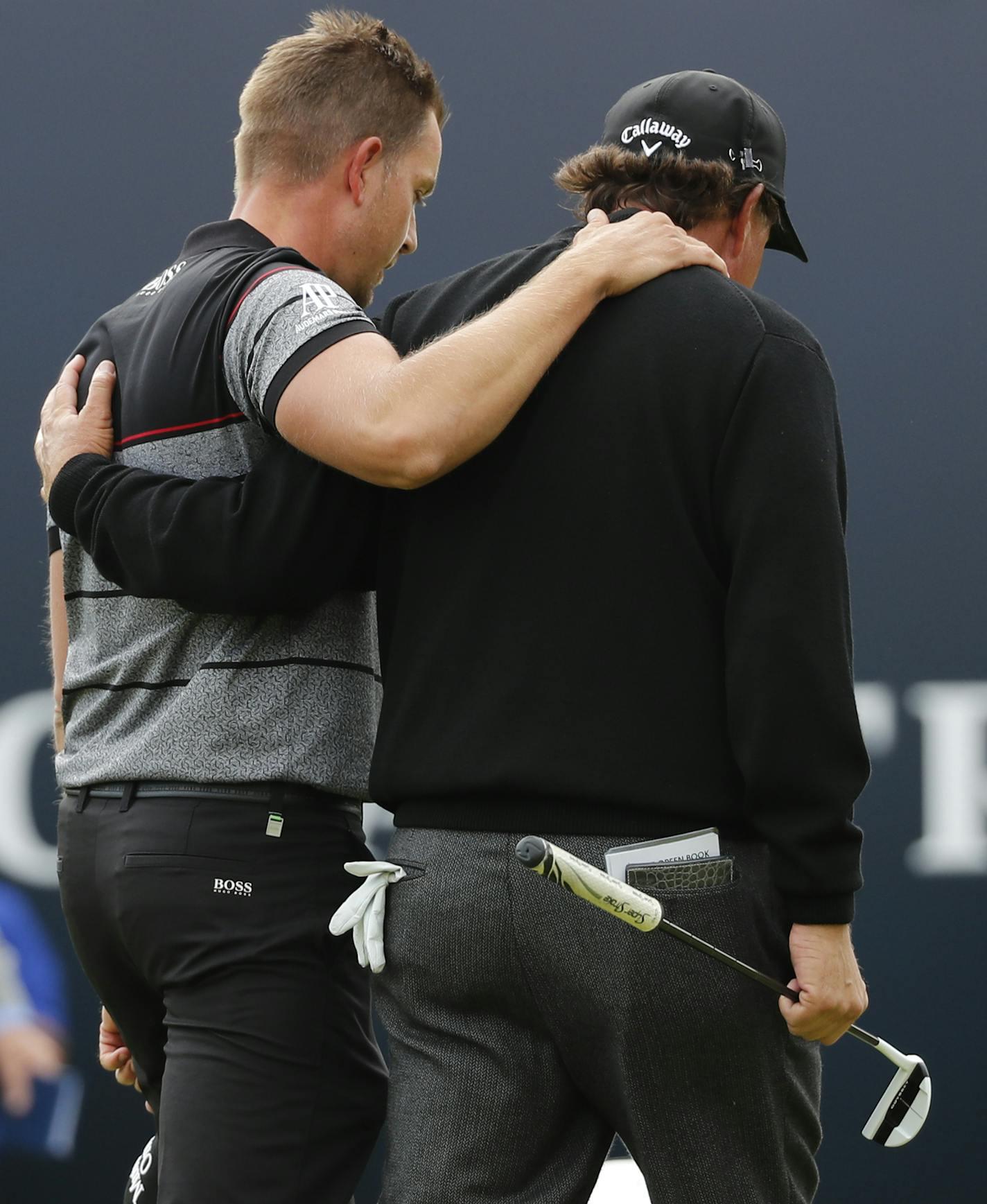 Henrik Stenson of Sweden, left and Phil Mickelson of the United States embrace as they walk off the 18th green after Stenson won the British Open Golf Championships at the Royal Troon Golf Club in Troon, Scotland, Sunday, July 17, 2016. (AP Photo/Ben Curtis)