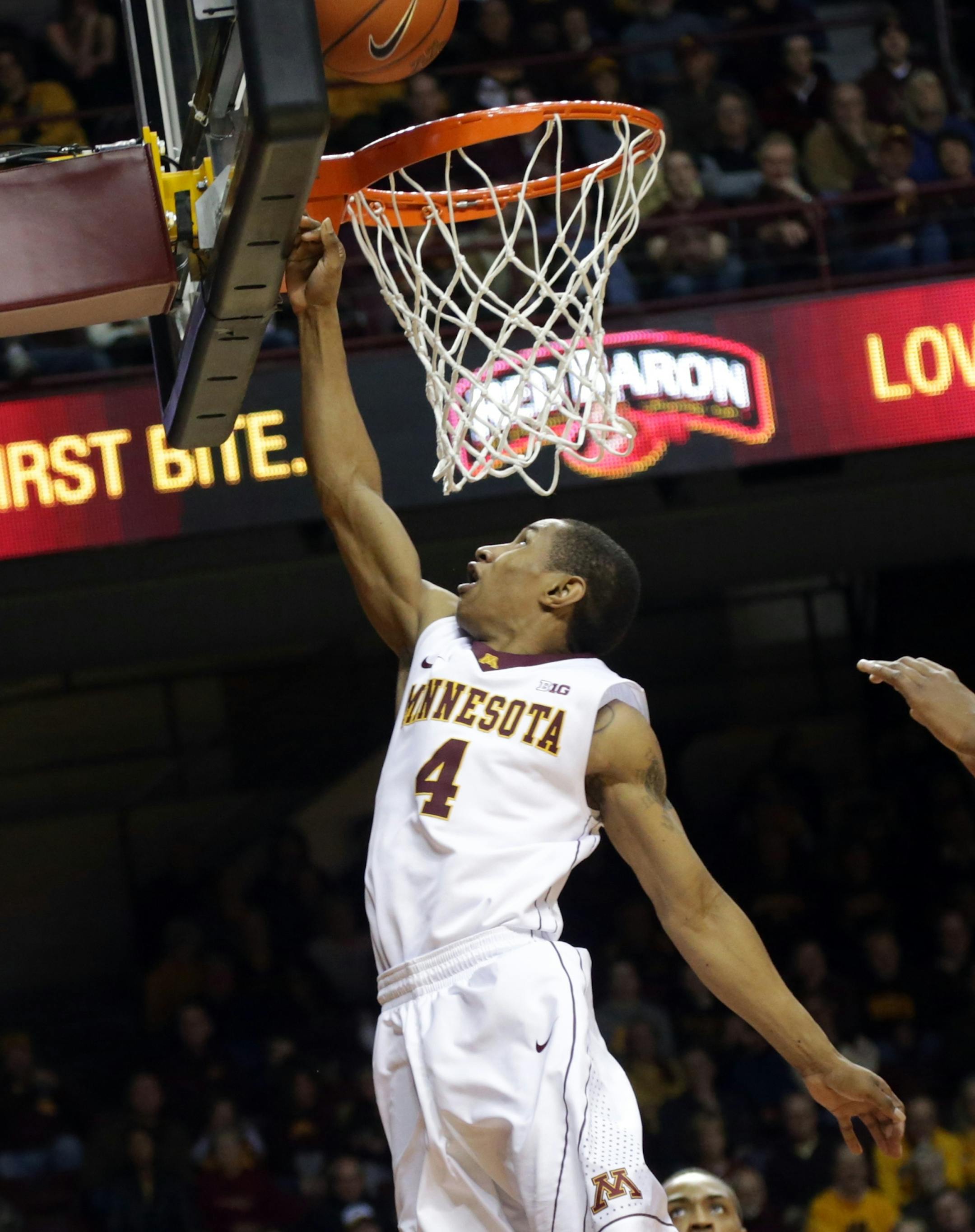 Minnesota&#x2019;s DeAndre Mathieu lays up a basket in the second half of an NCAA college basketball game against Rutgers, Saturday, Jan. 17, 2015, in Minneapolis. Minnesota won 89-80. (AP Photo/Jim Mone)