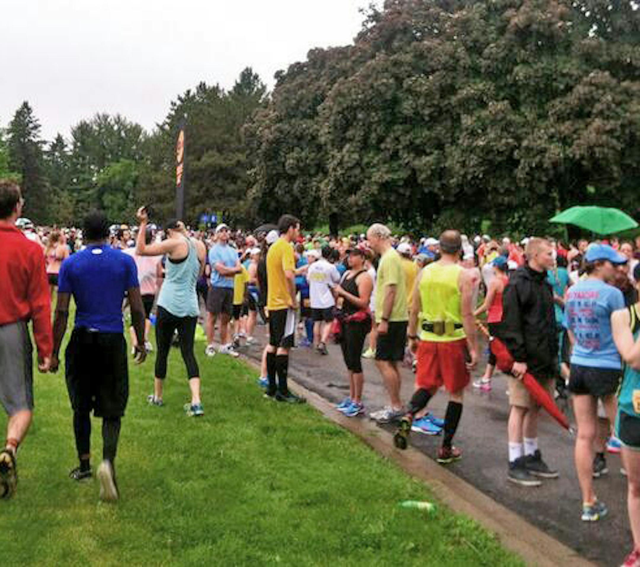 Runners milled around at the start line after the Minneapolis Marathon was called off Sunday because of rain. Budget ID: 265560