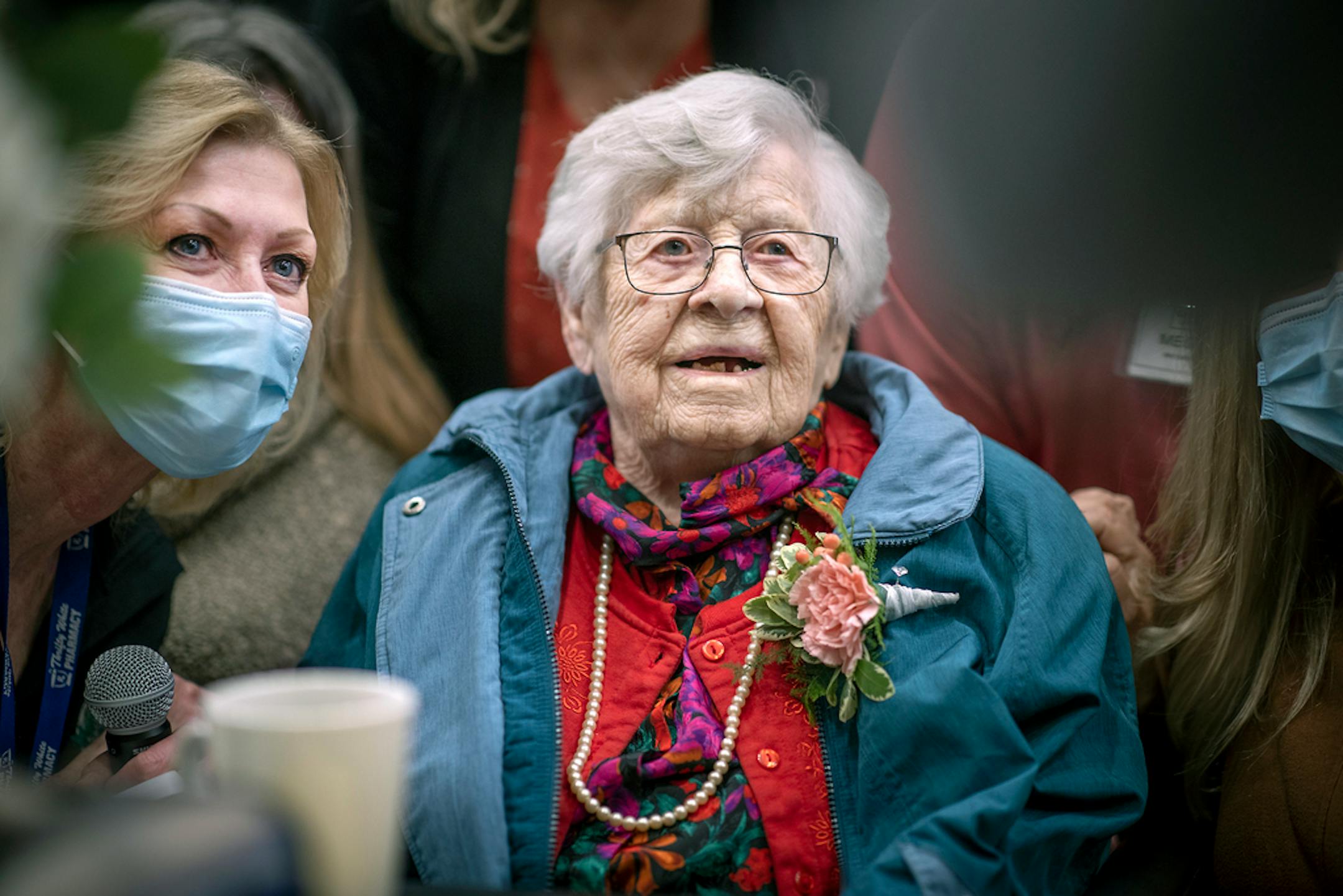 Erna Zahn's was greeted by friends and family including her nurse Cindee Krzmarzick, left, as she was wheeled into a birthday party held for her at the Sleepy Eye Coffee Company, Wednesday, April 14, 2021 in Sleepy Eye, MN. ] ELIZABETH FLORES • liz.flores@startribune.com