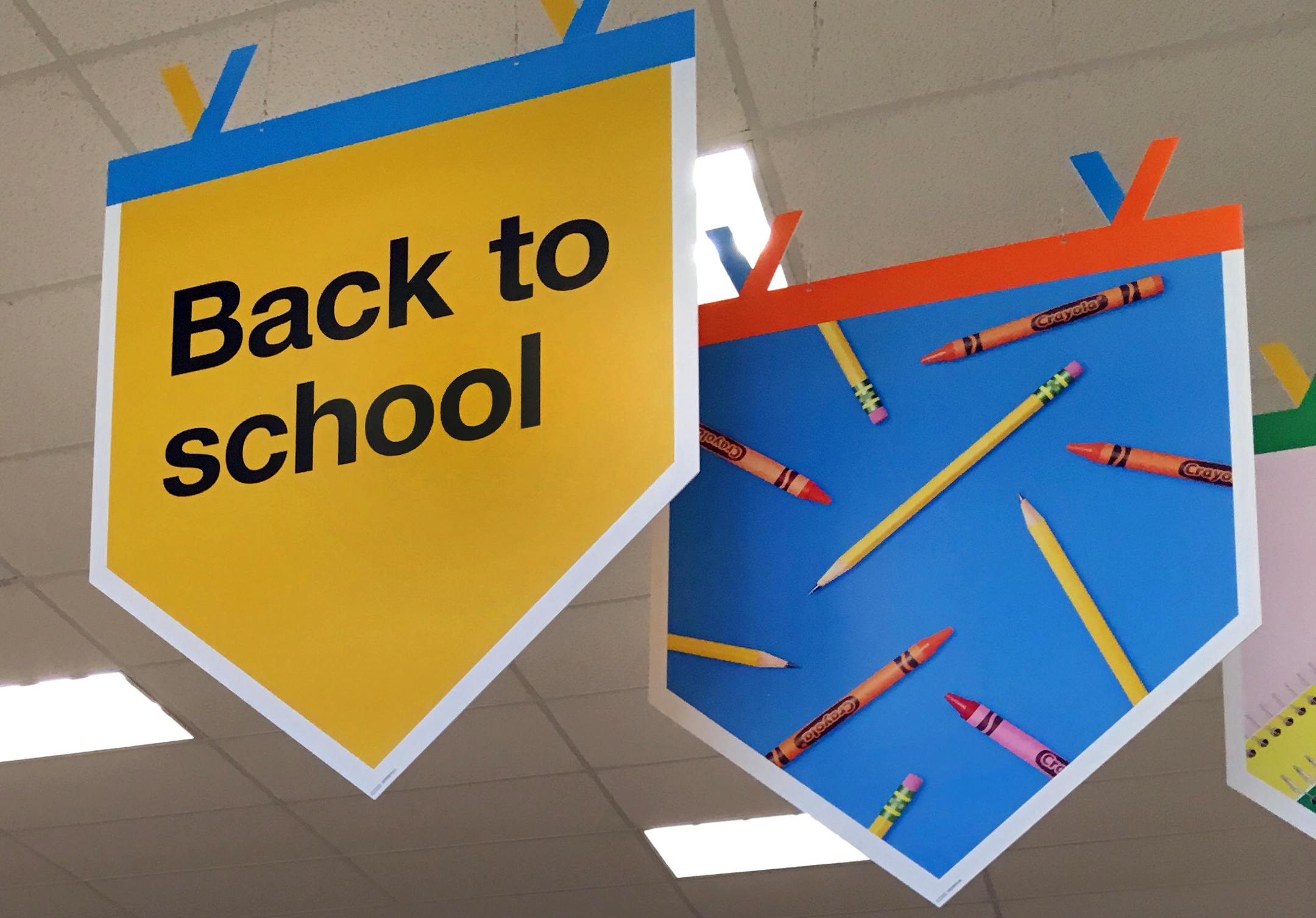 In this July 31, 2018 photo, "back to school" signage hangs in a store in Methuen, Mass. (AP Photo/Elise Amendola)