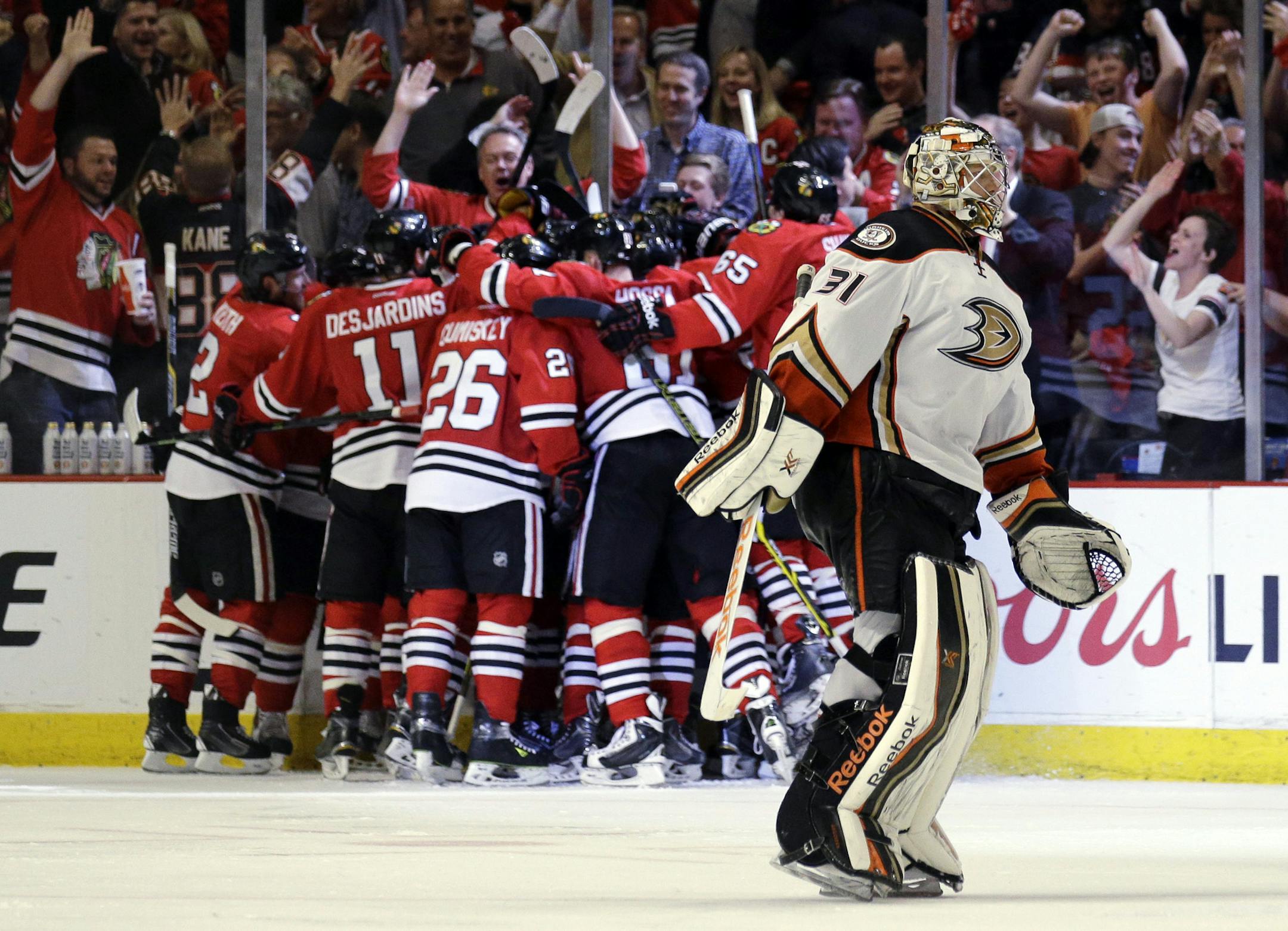 Anaheim Ducks goalie Frederik Andersen skates off the ice as Chicago Blackhawks celebrate an Antoine Vermette goal during the second overtime in Game 4 of the Western Conference finals of the NHL hockey Stanley Cup Playoffs, Saturday, May 23, 2015, in Chicago. Chicago won 5-4.(AP Photo/Nam Y. Huh)