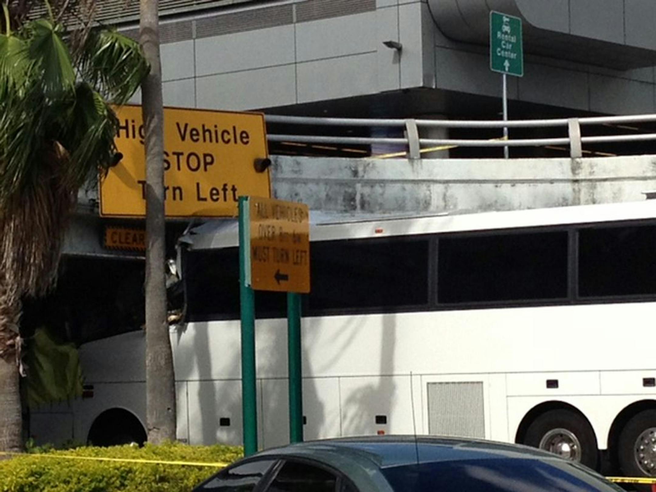 A bus is lodged into an overpass at the Miami International Airport on Saturday, Dec. 1, 2012. The vehicle was carrying over 30 people when it crashed into the structure. Authorities say buses typically are routed through the departures area, which has a higher clearance.