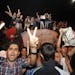 Palestinians chant slogans while holding pictures of Palestinian singer Mohammed Assaf as they celebrate his victory in a regional TV singing contest,