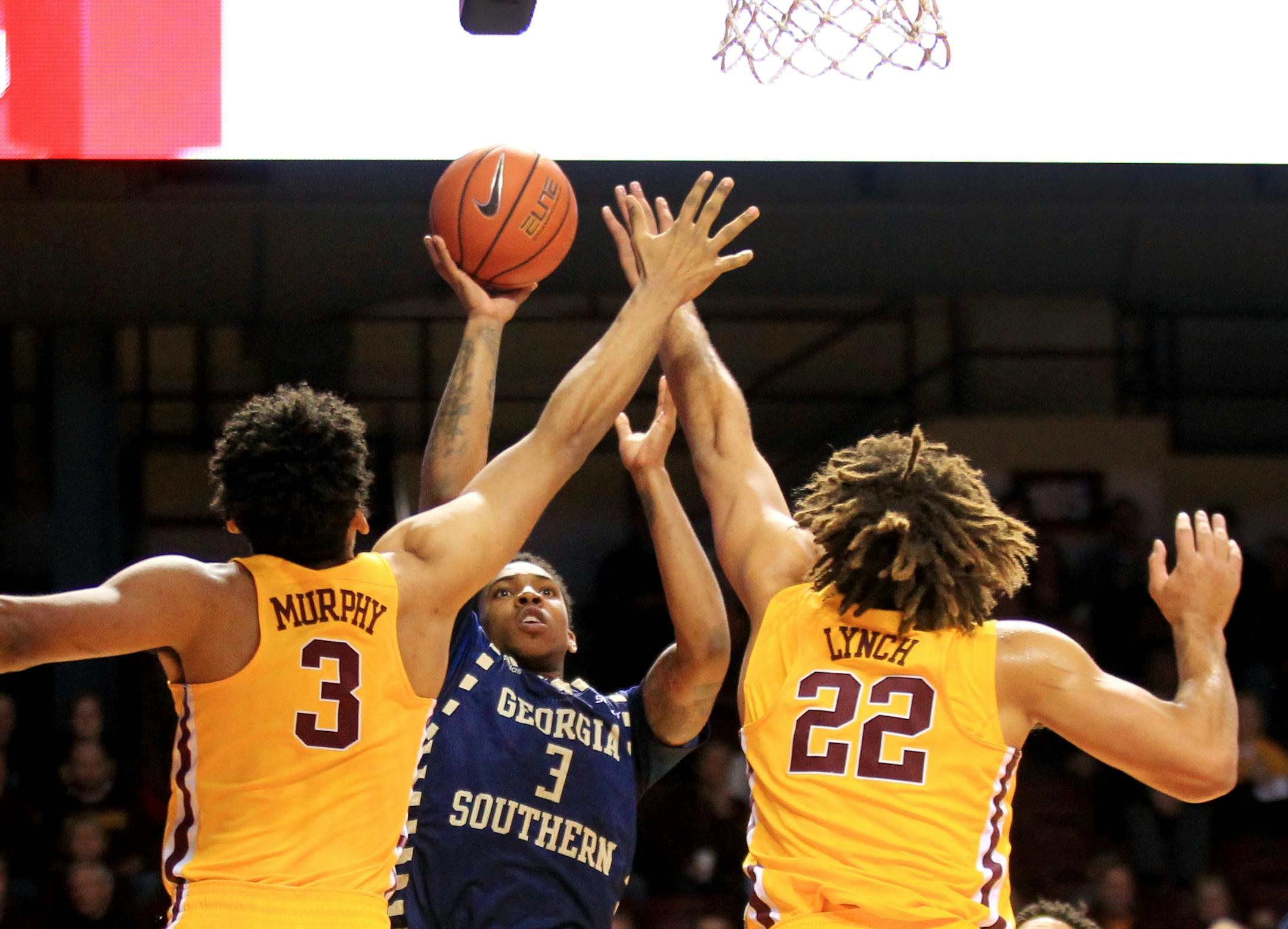 Georgia Southern guard Ike Smith (3) shoots between Minnesota forward Jordan Murphy (3) and center Reggie Lynch (22) in the first half of an NCAA college basketball game Friday, Dec. 9, 2016, in Minneapolis. (AP Photo/Andy Clayton-King)