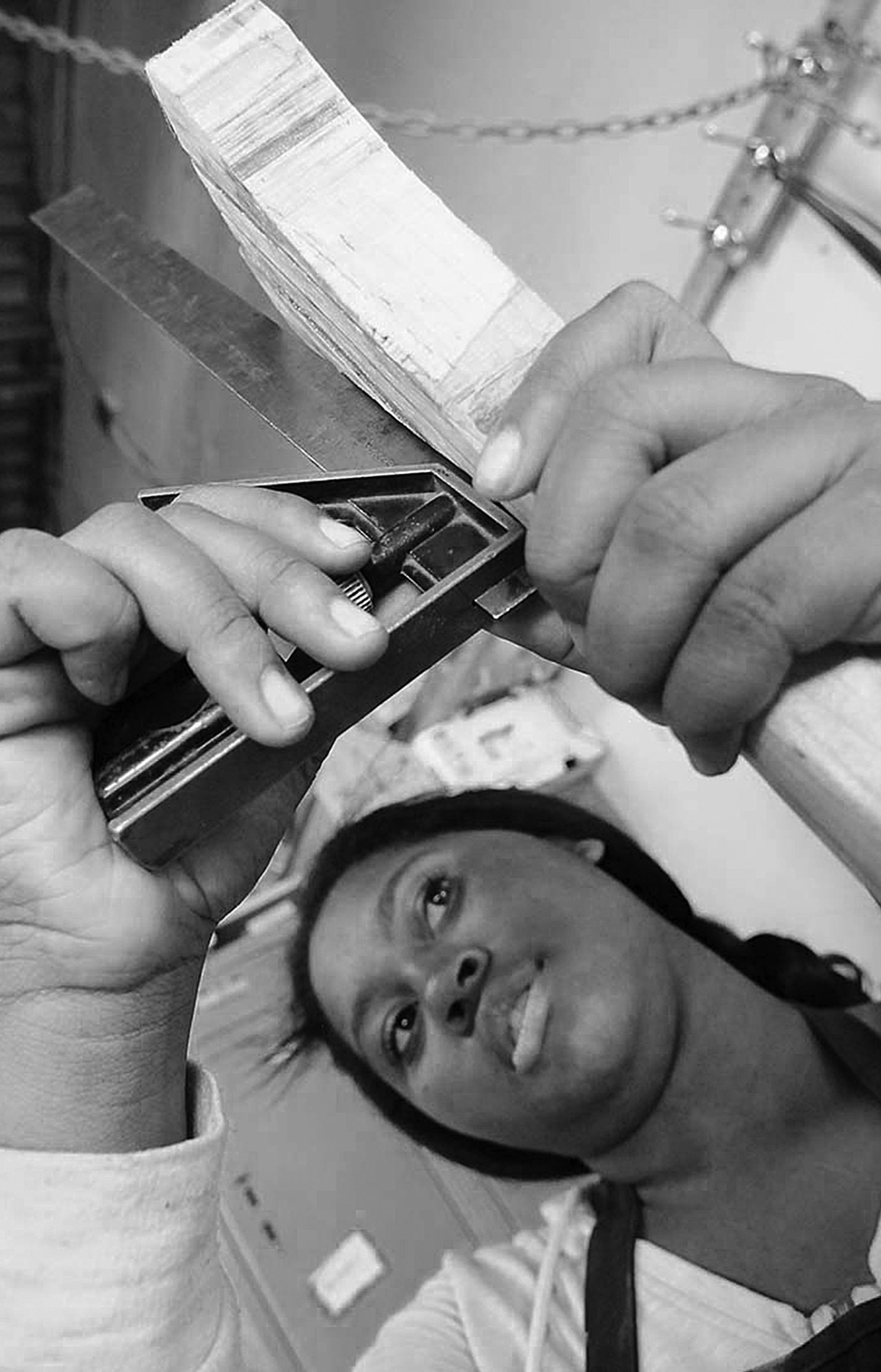 Photo by John Doman
Lanisha Wheatley (L), a junior at River's Edge Academy in St Paul and Andrew Vega, a senior at Jennings Community Learning Center attach ribs to a canoe frame at Urban Boatbuilders in St Paul Thursday afternoon June 19, 2014.