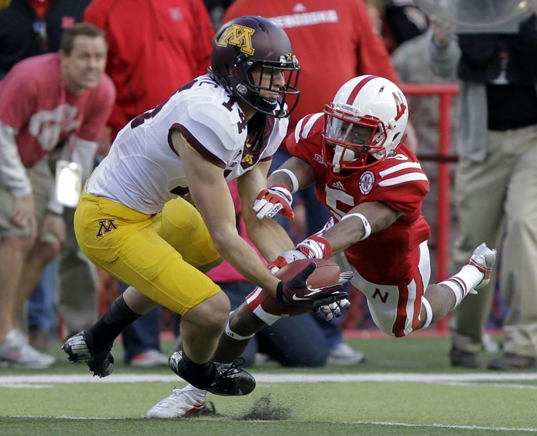 Nebraska' s Josh Mitchell, right, breaks up a pass intended for Minnesota's Isaac Fruechte
