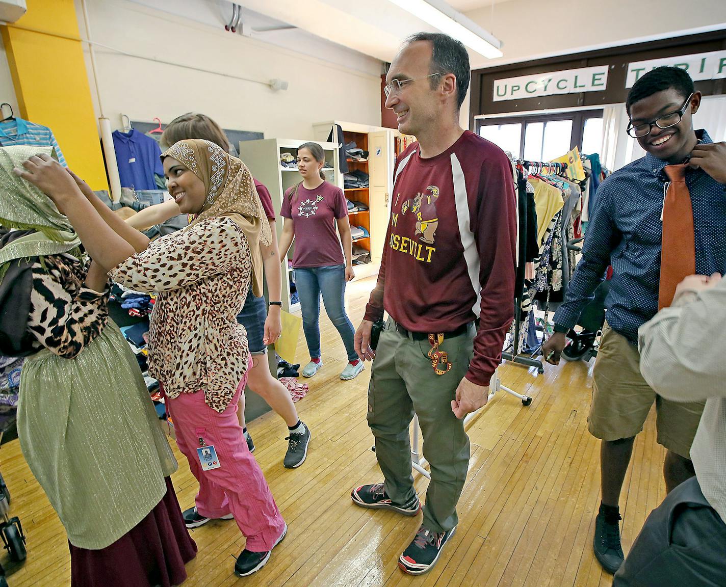 Roosevelt High School Principal Michael Bradley, center, greeted students as they prepared for an in-school prom Friday.