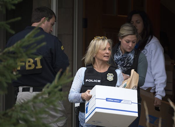 Raided: FBI and IRS agents left Jerry Ruzicka&#x2019;s Plymouth home after a raid in November, carrying boxes of seized materials.