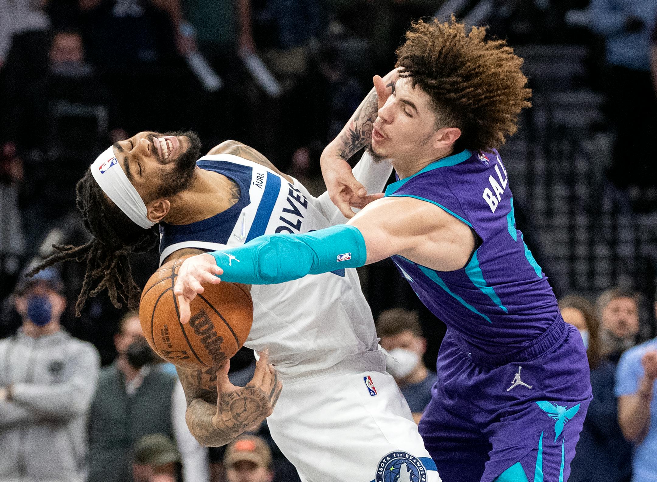 D'Angelo Russell (0) of the Minnesota Timberwolves is fouled by LaMelo Ball (2) of the Charlotte Hornets in overtime Tuesday, Feb. 15, at Target Center in Minneapolis, Minn. ] CARLOS GONZALEZ • cgonzalez@startribune.com