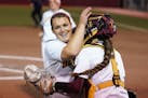 Gophers pitcher Amber Fiser was congratulated by catcher Emma Burns (5) after getting three outs Friday night.