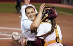 Gophers pitcher Amber Fiser was congratulated by catcher Emma Burns (5) after getting three outs Friday night.