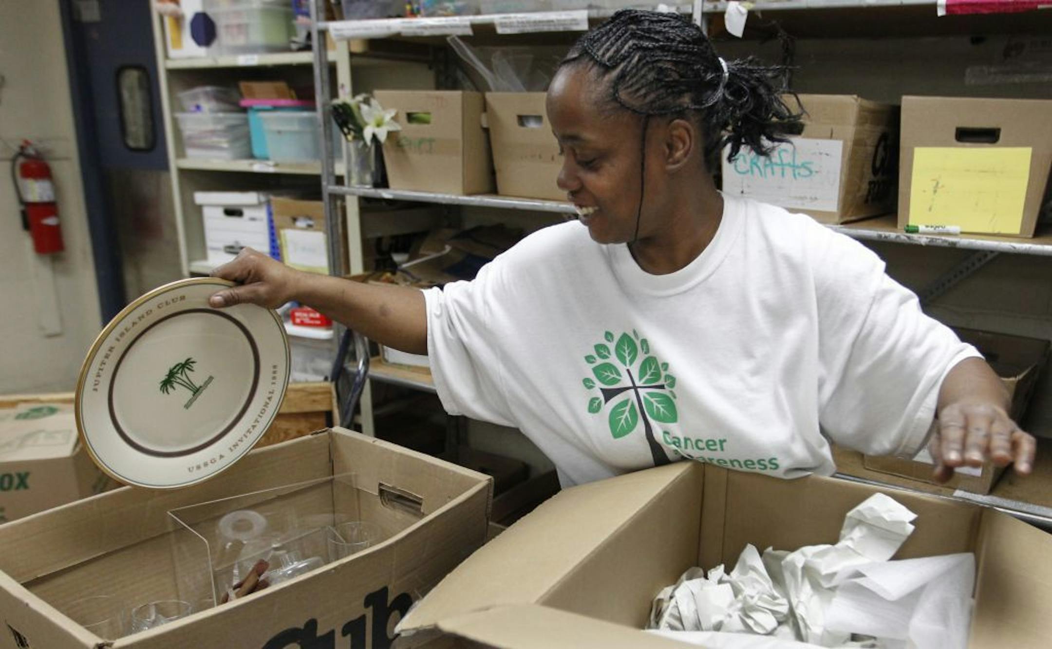 Richard Tsong-Taatarii/rtsong-taatarii@startribune.com Value Village, Leslie Tribbit sorts some donated china. She has worked there since October 2010.