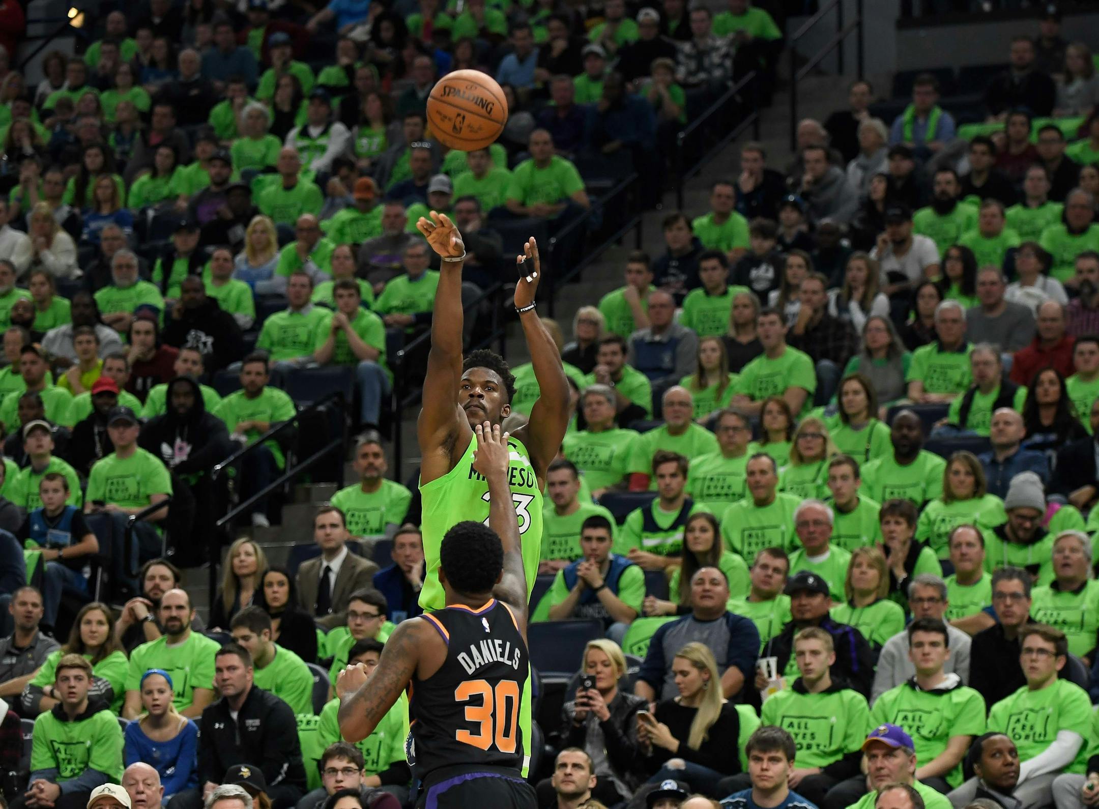 Minnesota Timberwolves guard Jimmy Butler (23) missed a three-point shot attempt under the defense of Phoenix Suns guard Troy Daniels (30) in the second half. ] AARON LAVINSKY ï aaron.lavinsky@startribune.com The Minnesota Timberwolves played the Phoenix Suns on Saturday, Dec. 16, 2017 at Target Center in Minneapolis, Minn.