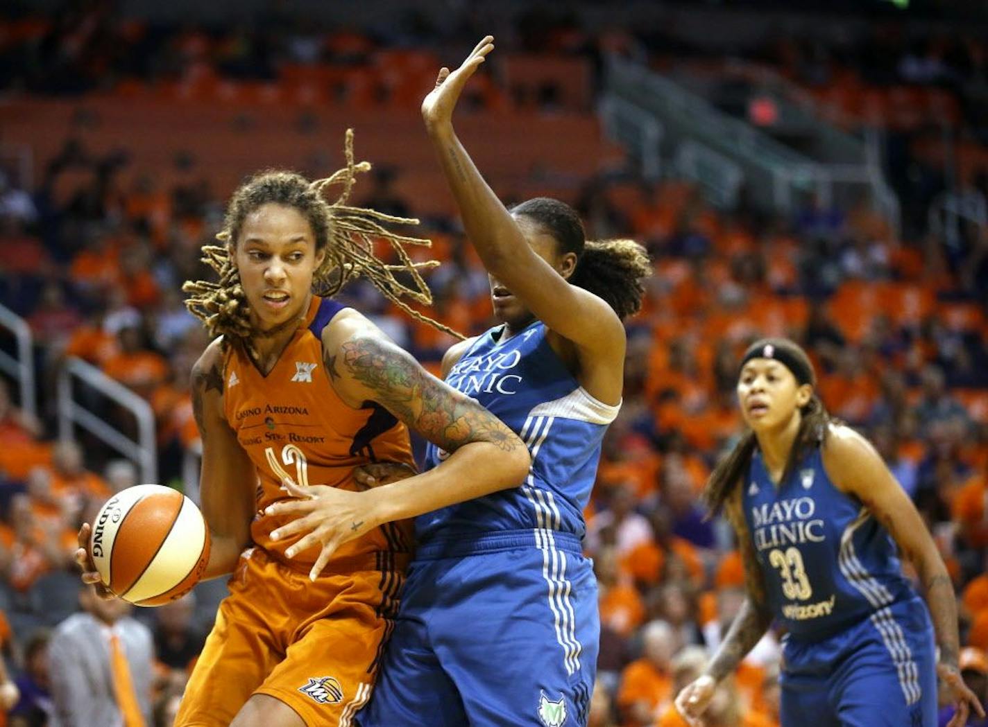 Minnesota Lynx forward Rebekkah Brunson, center, guards Phoenix Mercury center Brittany Griner during game 3 of the WNBA basketball semifinals in Scottsdale, Ariz., Sunday, Oct. 2, 2016.