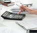 Close up of female accountant or banker making calculations. Savings, finances and economy concept. istock