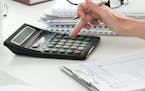 Close up of female accountant or banker making calculations. Savings, finances and economy concept. istock