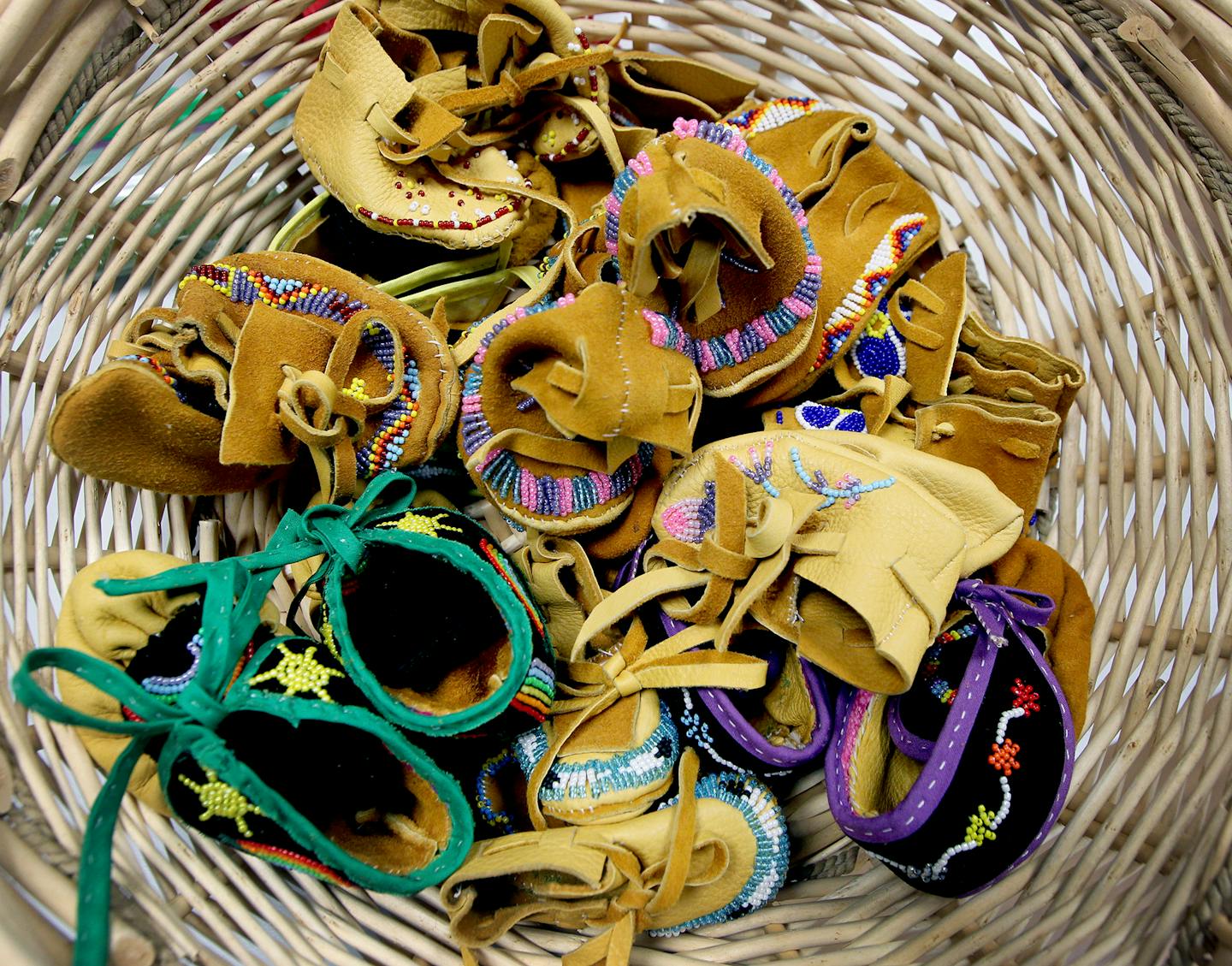 Finished moccasins were placed in a basket to be blessed with sage smoke and cedar from elders Linda Eaglespeaker and Donna LaChapelle at the American Indian Cultural Center. ] (ELIZABETH FLORES/STAR TRIBUNE) ELIZABETH FLORES &#x2022; eflores@startribune.com