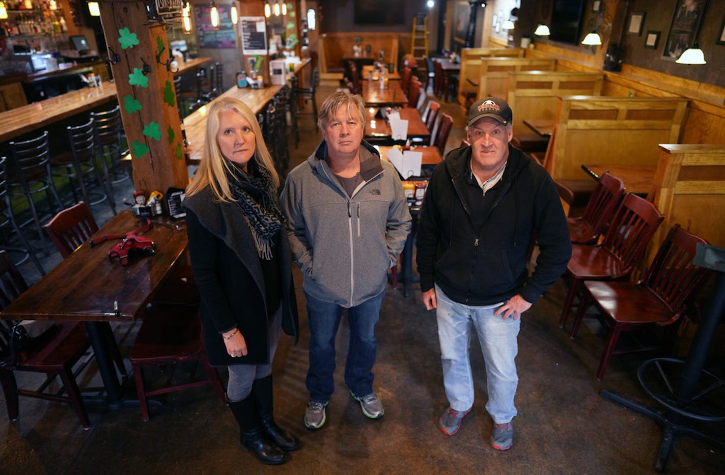 Mike Mulrooney, right, owner of Pog Mahone's bar, can't make April rent to landlords Ann and Mike Roess, left and center, of iMetro Property.