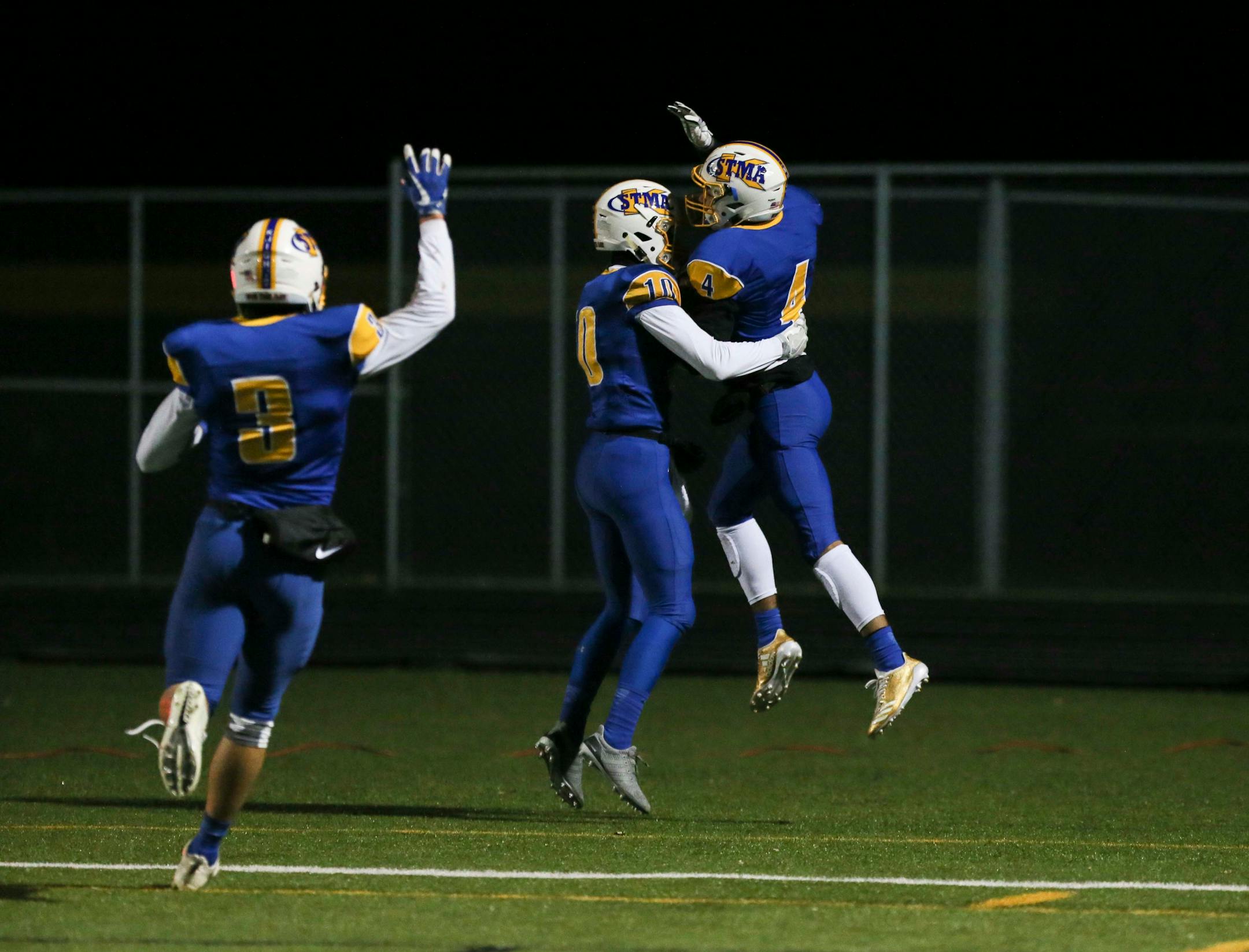 St. Michael-Albertville's Xavier Thurman (4), at right, celebrated a 74-yard touchdown with teammates Lance Kloster (10) and Ben Fiedler (3) in the second half. ] RENEE JONES SCHNEIDER • renee.jones@startribune.com Class 6A quarterfinals between St. Michael-Albertville and Maple Grove on Thursday, November 9, 2017, in Brooklyn Park, Minn.