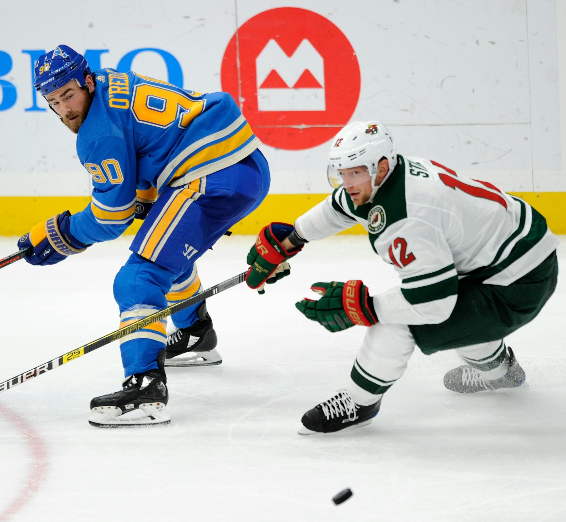 St. Louis Blues' Ryan O'Reilly (90) and Minnesota Wild's Eric Staal (12)