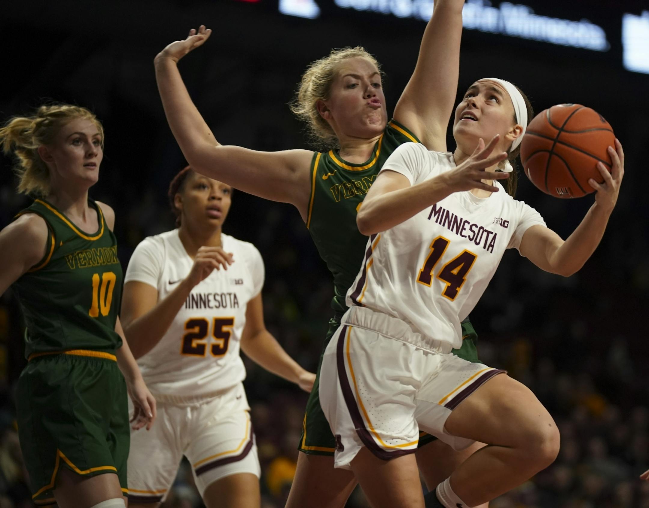 Minnesota Golden Gophers guard Sara Scalia (14) was fouled by Vermont Catamounts forward Abby Settelmeyer (25) while shooting in the fourth quarter. Scalia finished with 9 points.