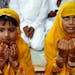 Young Muslim girls offer prayers at Eidgah during Eid al-Fitr in Allahabad, India, Saturday, Aug. 10, 2013. Muslims are celebrating Eid al-Fitr, marki