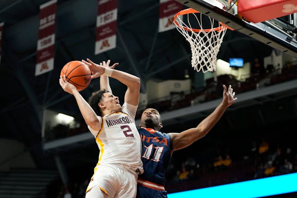 Minnesota guard Mike Mitchell Jr. (2) goes up for a shot as UTSA guard Isaiah Wyatt (11) defends during the first half of an NCAA college basketball g