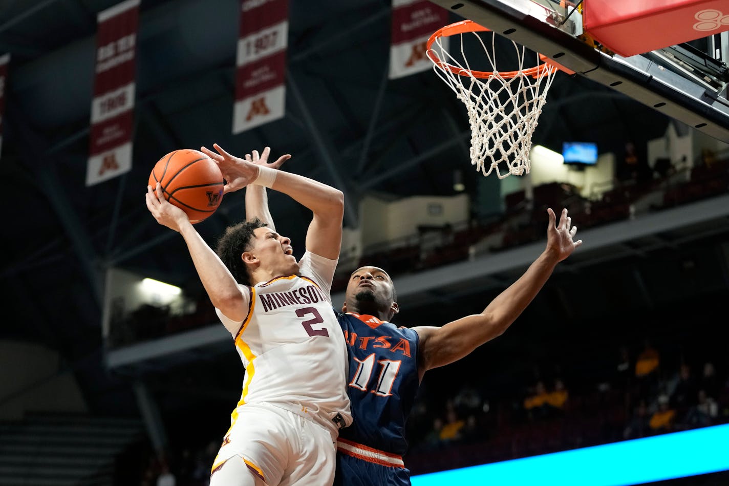 Minnesota guard Mike Mitchell Jr. (2) goes up for a shot as UTSA guard Isaiah Wyatt (11) defends during the first half of an NCAA college basketball game Friday, Nov. 10, 2023, in Minneapolis. (AP Photo/Abbie Parr)