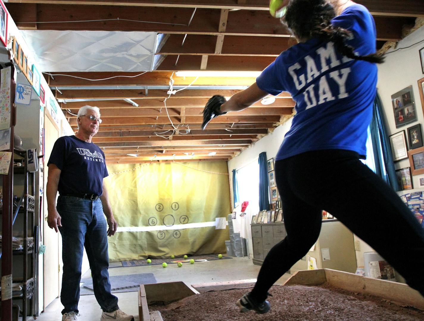 Richard Foore coached Brooke Pantila from Woodbury in pitching on Saturday, April 20, 2013 at his house in Rosemount, MN. Some of the Twin Cities' best fast pitch girls' softball players are taught by old-time men's fast pitch pitchers like Foore. ] NICOLA LOSIK* nicola.losik@startribune.com