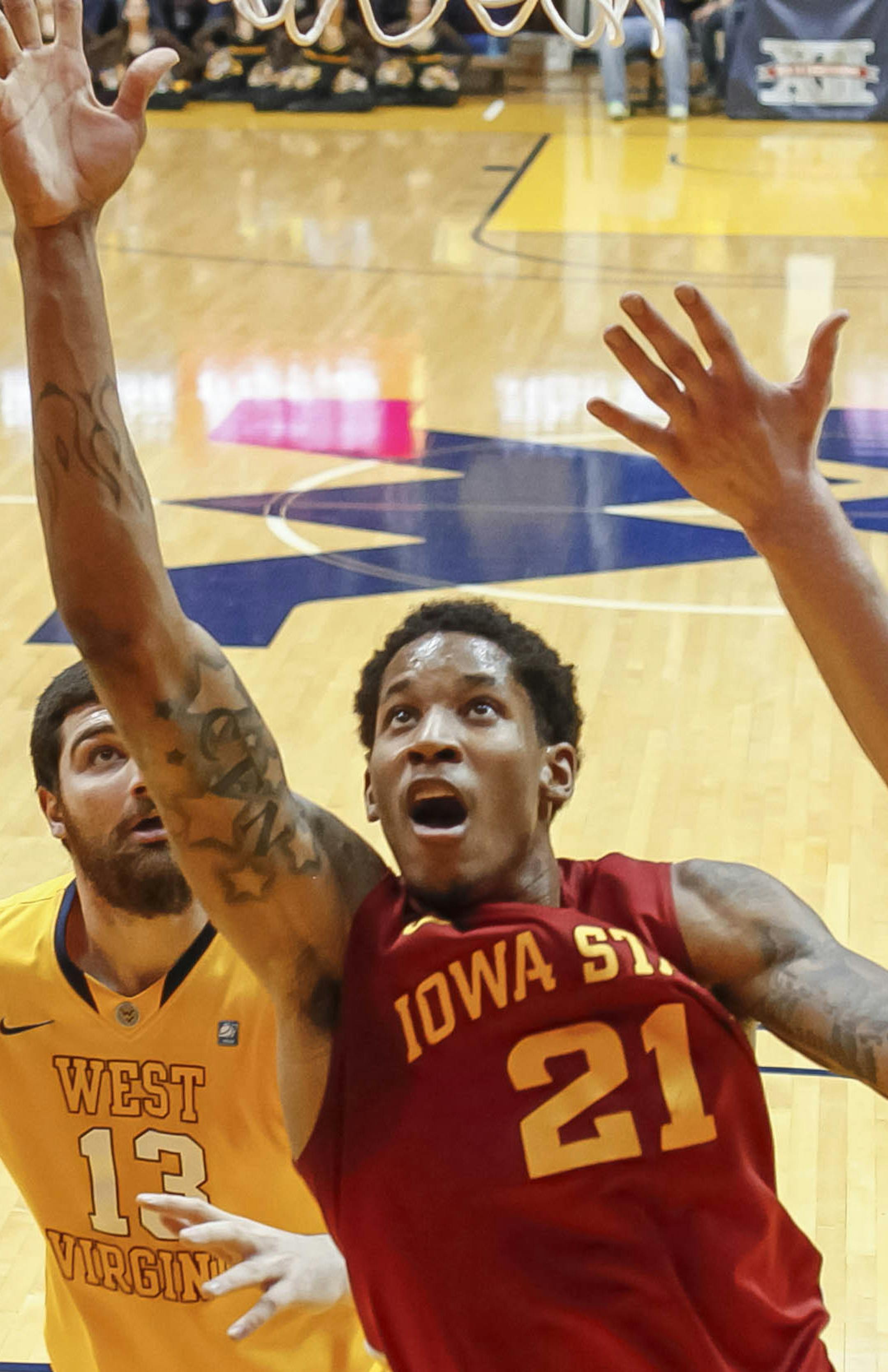 Iowa State's Will Clyburn (21) scores against West Virginia during the first half of an NCAA college basketball game at WVU Coliseum in Morgantown, W.Va., on Saturday, March 9, 2013. (AP Photo/David Smith) ORG XMIT: MIN2013032115285573