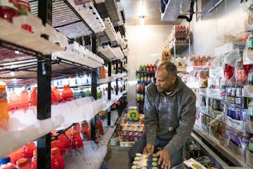 Adil Albosaad, the owner of E&L Supermarket and Deli, restocked the cooler.