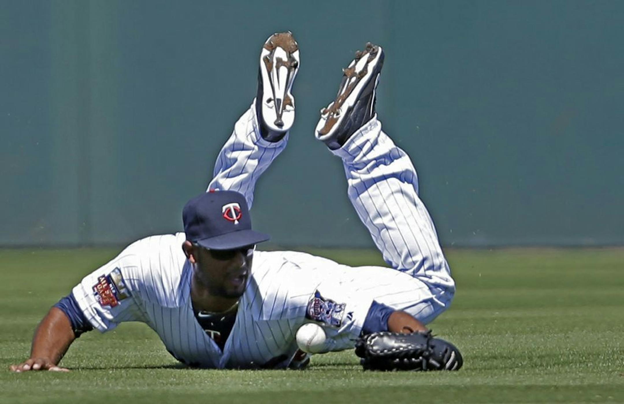 Minnesota Twins center fielder Aaron Hicks (32) dives for a single hit by Boston Red Sox Mike Napoli in the second inning of an exhibition baseball game in Fort Myers, Fla., Thursday, March 13, 2014.