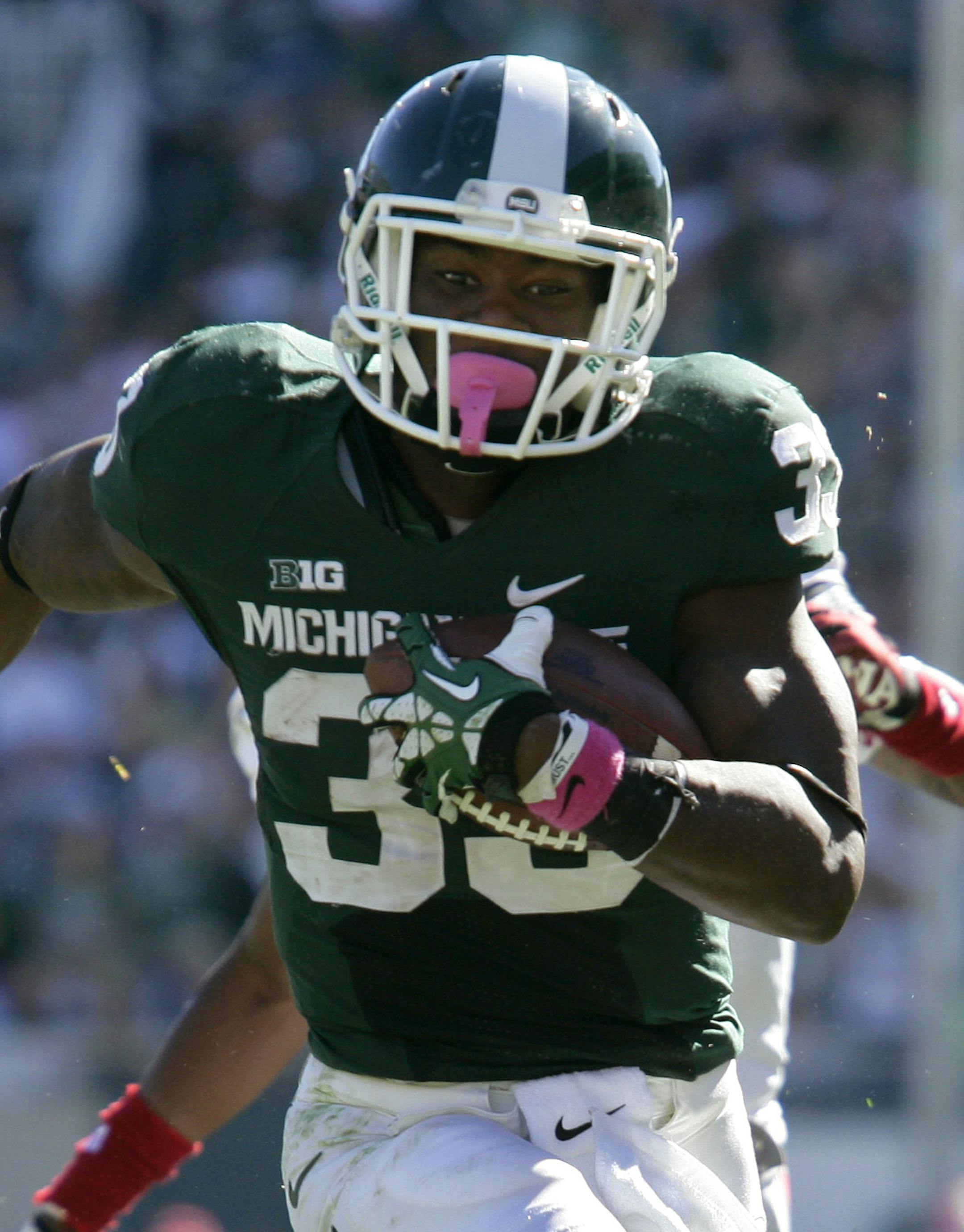 Michigan State's Jeremy Langford, right, runs past Indiana's Mark Murphy (37) for a 32-yard touchdown during the third quarter of an NCAA college football game, Saturday, Oct. 12, 2013, in East Lansing, Mich. Michigan State won 42-28. (AP Photo/Al Goldis) ORG XMIT: ELJ106