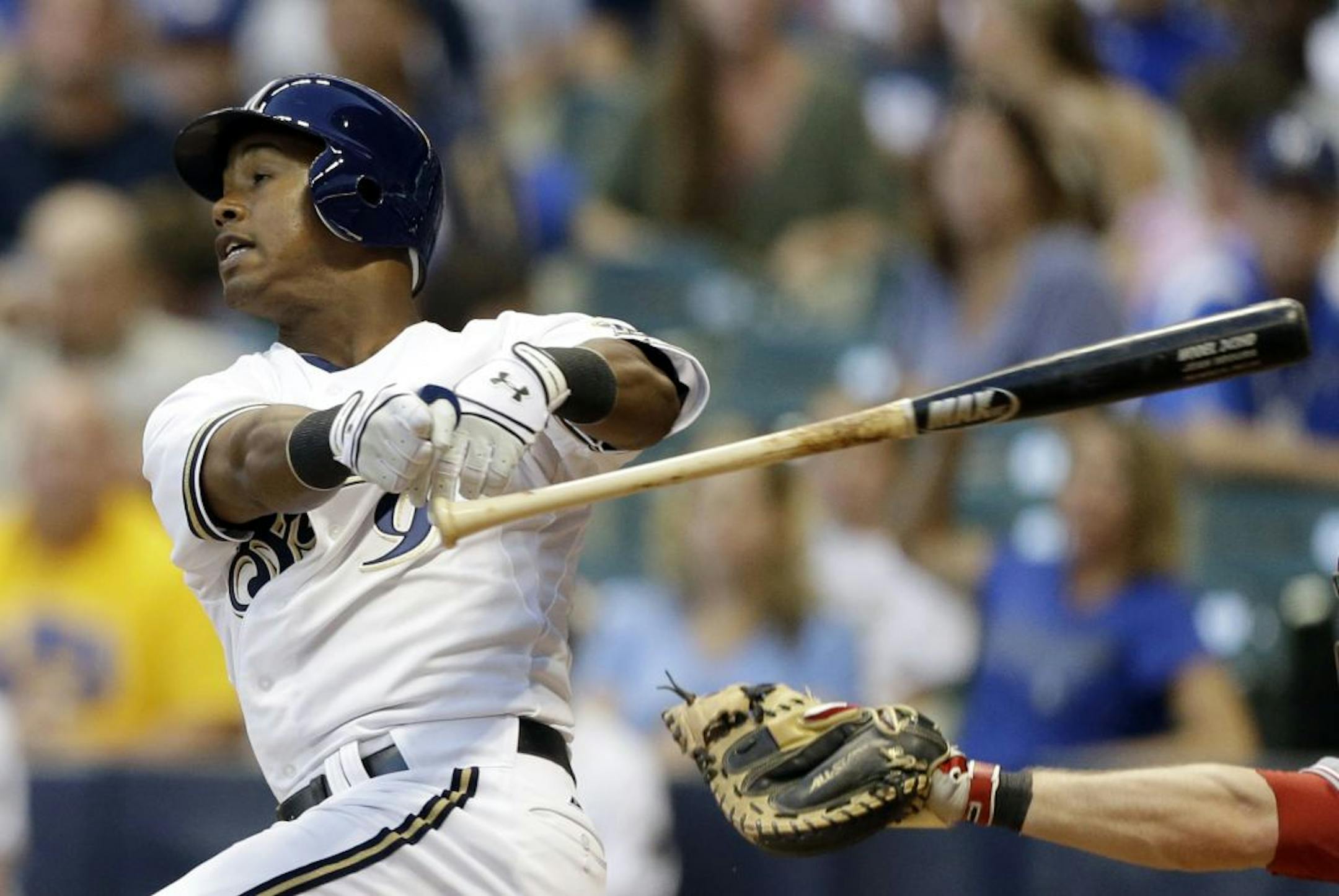 Milwaukee Brewers' Jean Segura loses his bat on a swinging strike against the Cincinnati Reds during the third inning of a baseball game Monday, Aug. 6, 2012, in Milwaukee.
