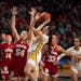 Indiana’s Mackenzie Holmes (54), shown here defending Gophers guard Maggie Czinano, was named the Big Ten’s defensive player of the year.