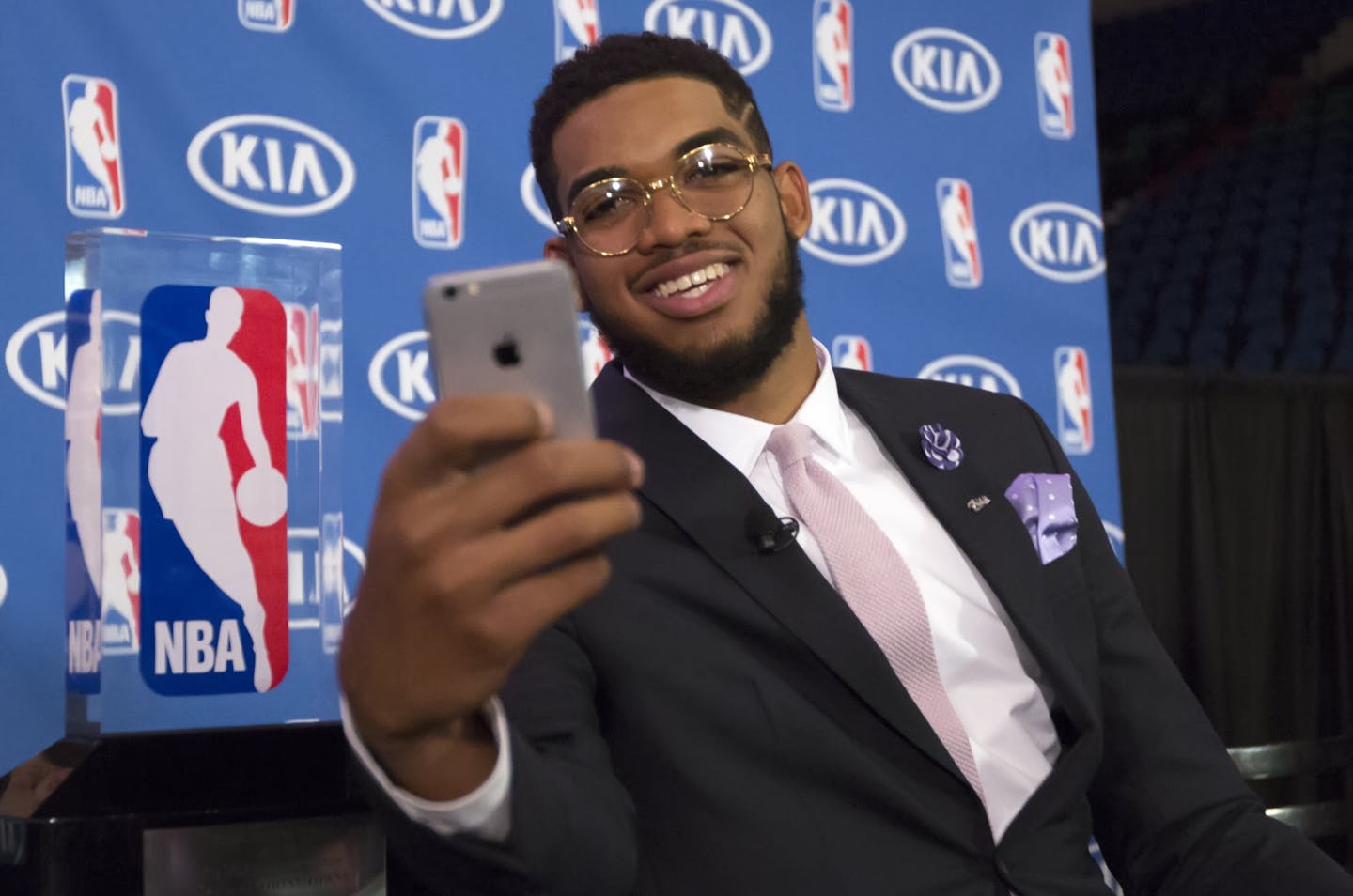 Timberwolve's Karl-Anthony Towns takes a selfie with the NBA Rookie of the Year trophy after a news conference announcing the award Monday morning at Target Center.