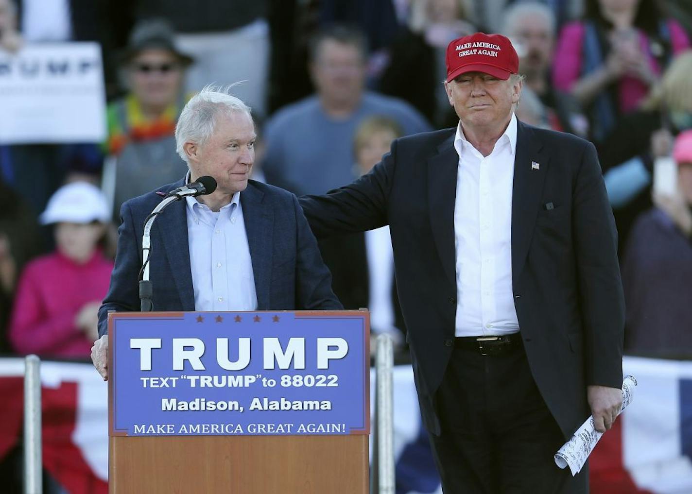 Republican presidential candidate Donald Trump, right, stands next to Sen. Jeff Sessions, R-Ala., as Sessions speaks during a rally Sunday, Feb. 28, 2016, in Madison, Ala.